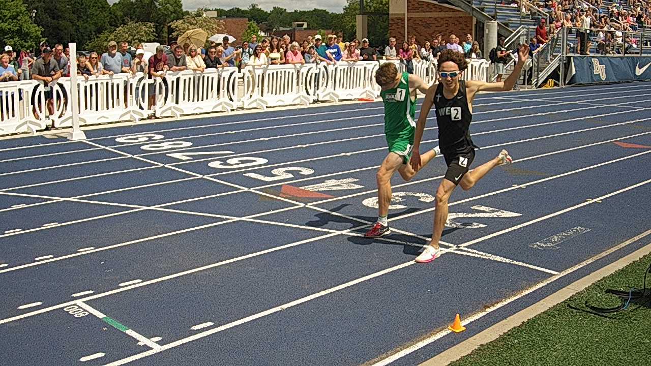 The Athletes Running On The Race Track